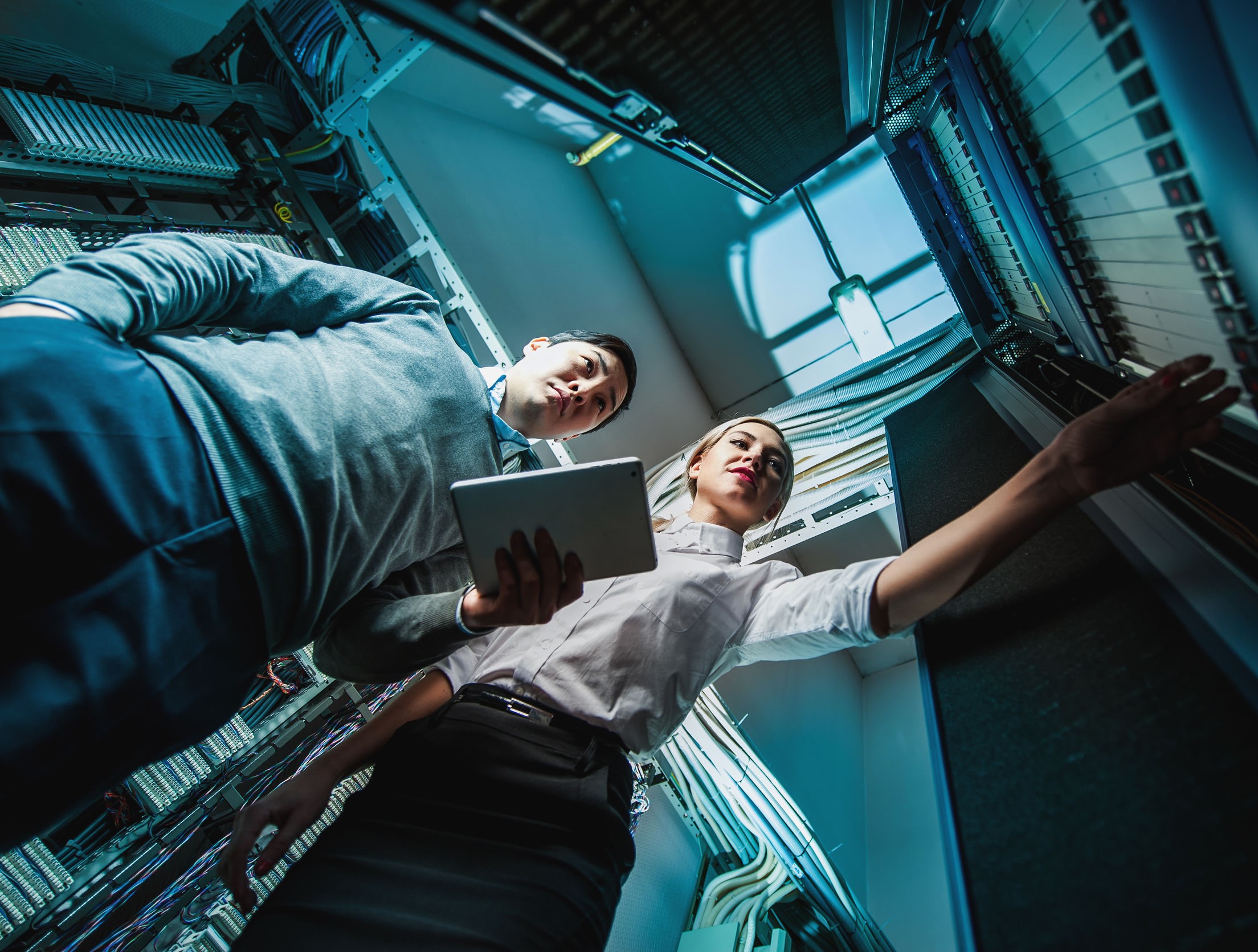 Young engineers businessmen in network server room